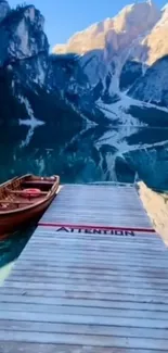 Peaceful lake with mountains and a dock.