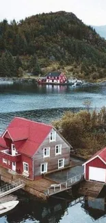 Scenic view of red lakeside house surrounded by water.