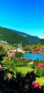 Lakeside village with vibrant rooftops and green hills under a clear blue sky.