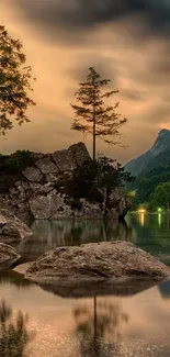 Tranquil lake at sunset with trees and mountains reflecting in calm waters.