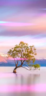 Wallpaper of a tree in a tranquil lake with pastel skies and mountains.