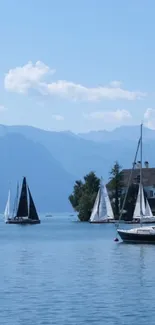 Sailboats on a tranquil lake with mountains in the background.