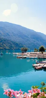 Tranquil lakeside wallpaper with turquoise lake and hills.