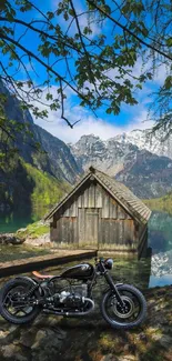 Vintage motorcycle by a serene lakeside cabin, surrounded by mountains.