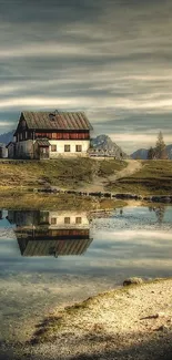 Rustic lakeside cabin reflecting in serene mountain waters.