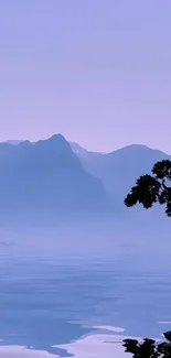 Lavender landscape with mountains and tree reflected in water, serene and calming.