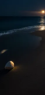 Tranquil beach under moonlight with shell and waves.