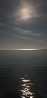 Moonlight reflecting on a calm ocean under a clear night sky.