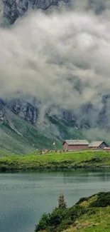 Mountain lake with misty clouds and lush green hills.