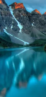 A tranquil mountain lake with turquoise water reflecting rocky peaks.