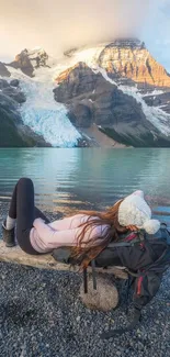 Woman relaxing by a tranquil mountain lake.