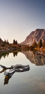 Tranquil mountain lake with reflection at sunrise.