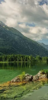 Tranquil mountain lake with lush greenery and calm waters.