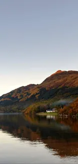 Tranquil mountain lakeside view with autumn colors and reflections.