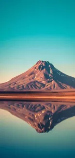 Serene mountain reflection in a calm lake with a blue sky.