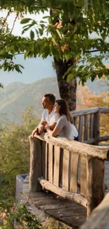 Couple enjoying tranquil mountain view on a wooden deck.