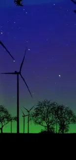 Starry night sky with windmills silhouetted in a tranquil landscape.