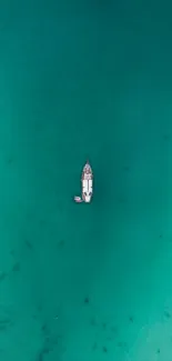 A solitary boat on turquoise water, making a tranquil phone wallpaper.