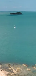 Serene turquoise ocean view with distant island.