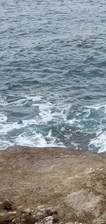 Tranquil ocean waves on a rocky shoreline.