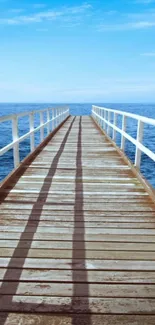 Serene ocean view with a wooden pier extending out over blue water.