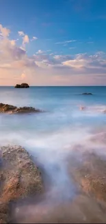 Serene ocean view with sunset sky and calming waves.