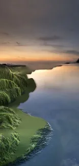 Tranquil sunset over ocean with green coastline.