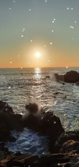 Sunset over ocean with sparkling water and rocks in the foreground.