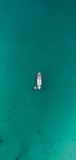 Boat floating on turquoise ocean water wallpaper.