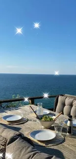 Ocean view from a coastal terrace dining area with a clear blue sky.