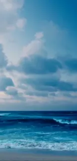 Serene ocean view with waves under a cloudy sky.