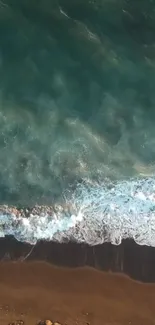 Aerial view of tranquil ocean waves meeting a sandy beach.