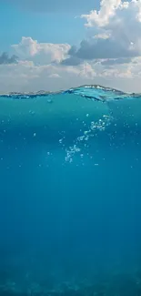 A stunning mobile wallpaper of clear blue ocean waves under a bright sky.