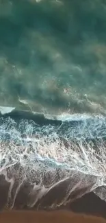 Aerial view of ocean waves on a sandy beach, captured in a tranquil mobile wallpaper.