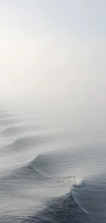 Serene ocean waves in soft grey hues for a minimal mobile wallpaper.
