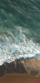 Aerial view of ocean waves and sandy shore on a mobile wallpaper.