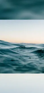 Tranquil teal ocean waves with subtle sunset sky.