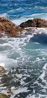 Serene ocean waves crashing on rocky shores in calming blue hues.