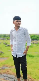 Young man standing on a nature path in lush greenery.