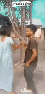 Two people practicing outside under tree shade.