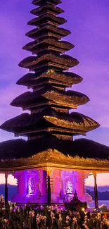 A beautiful pagoda at sunset with a vibrant purple sky.