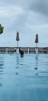 Serene poolside view with calm waters and sky