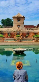 Serene poolside scene with historic building and clear blue sky.