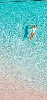 Person floating in a turquoise pool, creating a serene and tranquil scene.