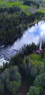 A serene river, green forest, and cabin wallpaper.