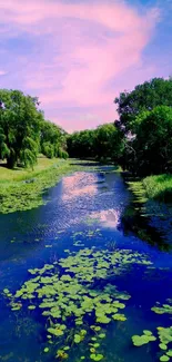 Tranquil river with greenery and blue sky wallpaper.