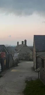 Rustic barns under a darkening evening sky at dusk.