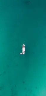 Aerial view of a single boat on turquoise sea waters.