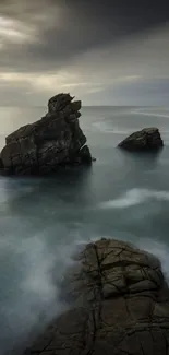 A calm ocean scene with rocky formations under a cloudy sky, perfect for nature lovers.