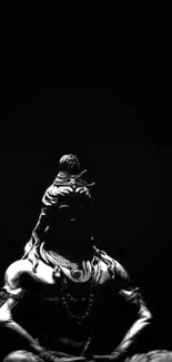 Silhouette of Shiva against black background, meditation theme.